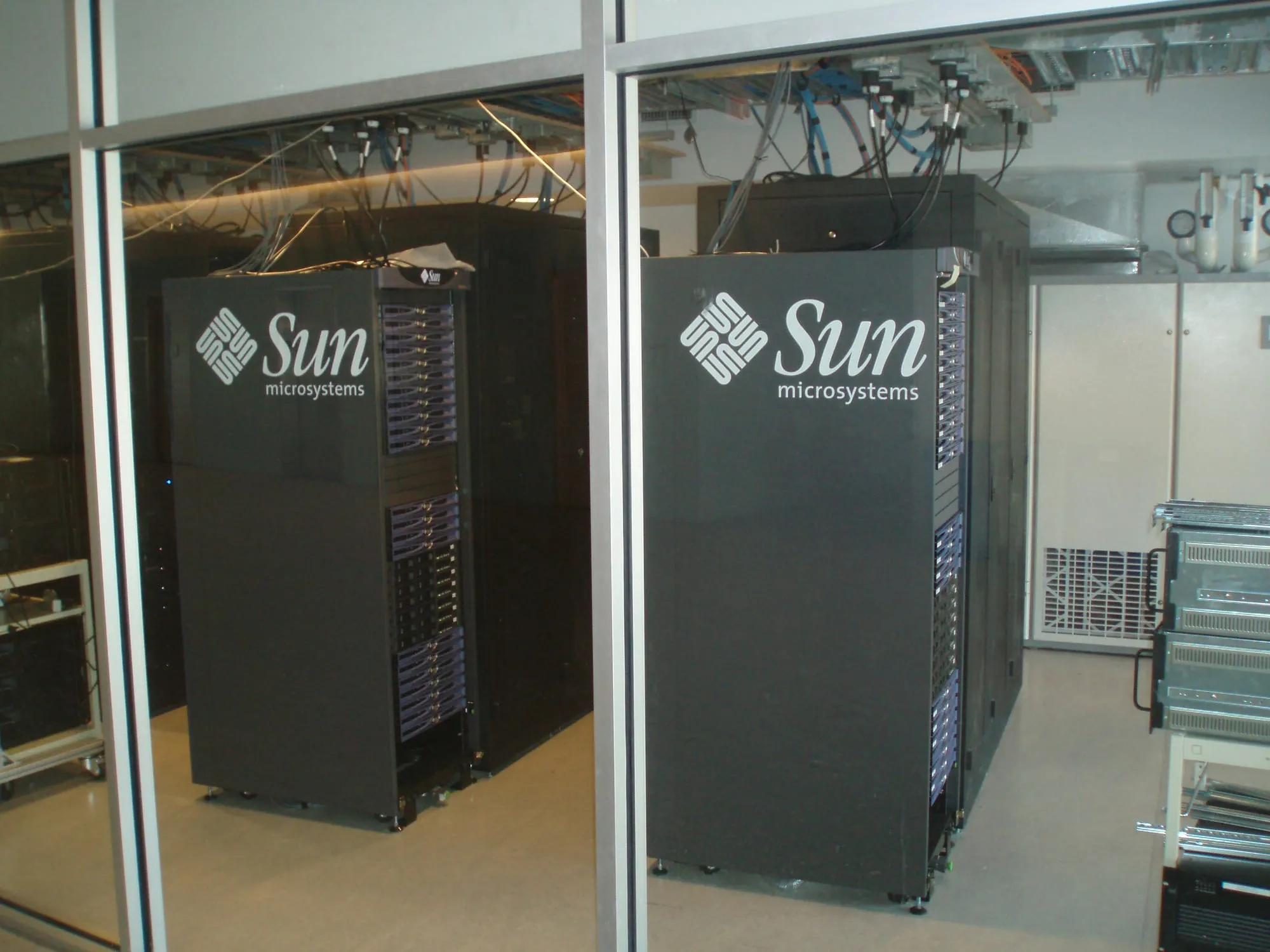 Two server cabinets behind a glass wall
